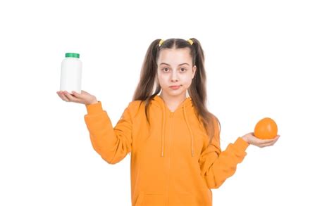 Premium Photo Kid Choose Between Orange Fruit And Vitamin Pill In Jar