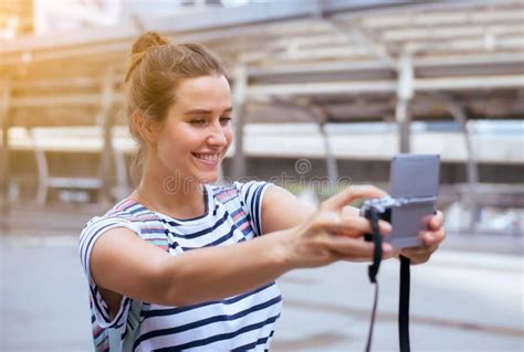 Happy And Smiling Female Traveler Is Making Her Selfie In The City