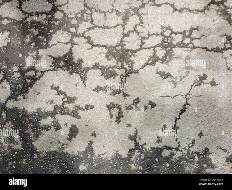 Cracks In The Asphalt Partially Wet Asphalt After Skinning Texture Of