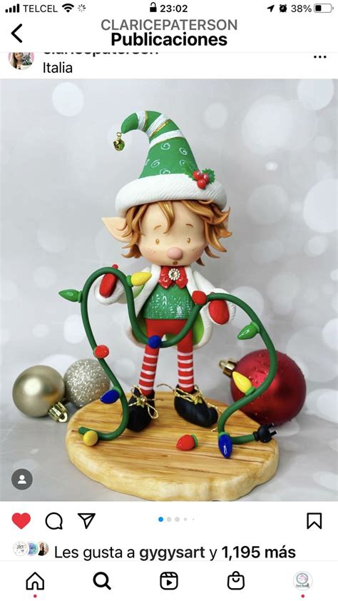 A Christmas Figurine Is Displayed On A Wooden Board With Lights And