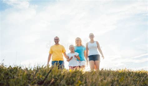 Family Walking in Sunset Over a Summer Meadow Stock Image - Image of ...