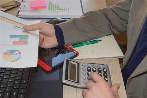 Businessman Using A Calculator To Calculate The Numbers Businessman