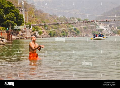 Hindu Monk Praying In The Sacred Waters Of Holy Ganges River Ram Jhula