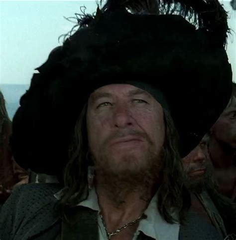 a man wearing a black hat standing next to other men in pirate costumes and beards