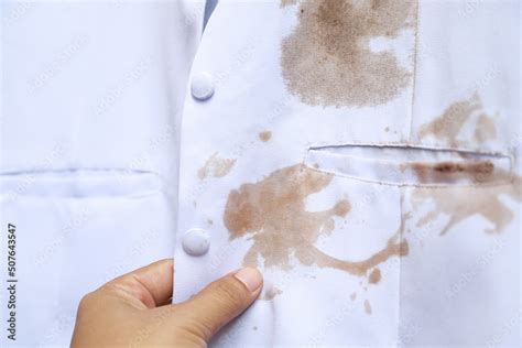 Hand show dirty sauce stain on white shirt from eating in home of daily ...