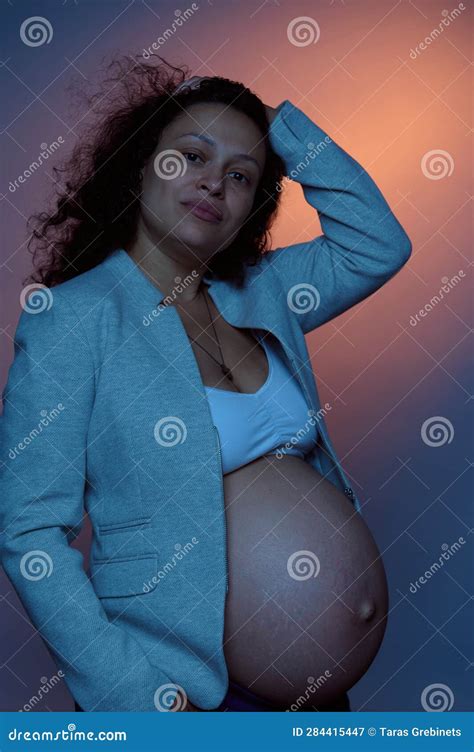 Beautiful Multi Ethnic Pregnant Woman Looking At Camera Posing With