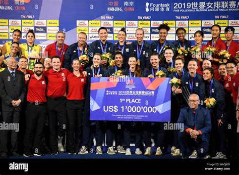 Players Of United States Women S National Volleyball Team Pose With Their Trophy After Winning