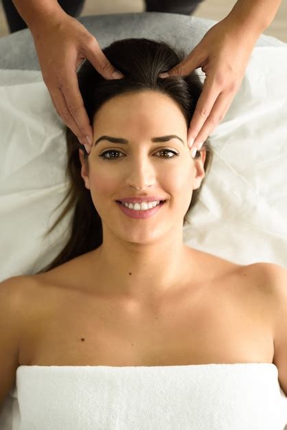 Free Photo Young Smiling Woman Receiving A Head Massage In A Spa Center