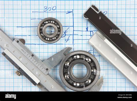 Calipers Bearing And Square On The Background Of Graph Paper Stock