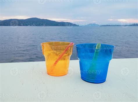 Two Colourful Empty Plastic Cups With Spoons On The Beach 4642821 Stock