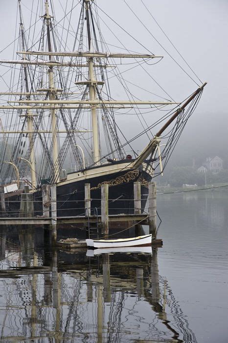 An Old Sailing Ship Is Docked In The Water