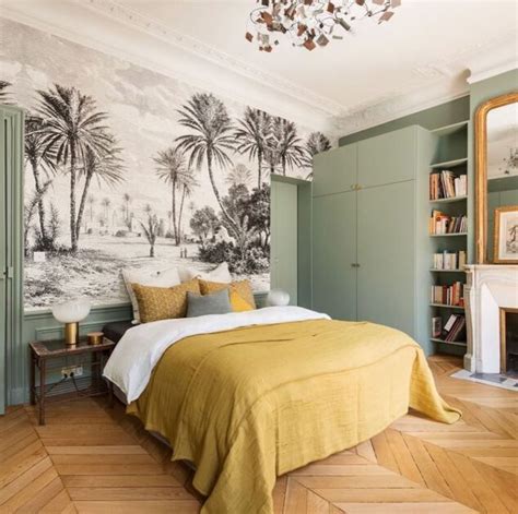 A Bedroom Decorated In Green And Yellow With Palm Trees Painted On The