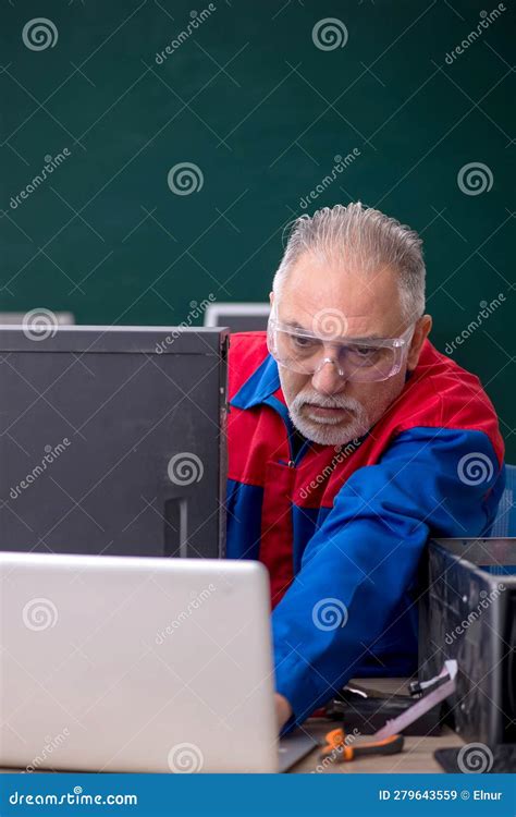 Old Repairman Repairing Computers In The Classroom Stock Image Image