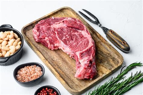 Premium Photo Raw Rib Eye Beef Marbled Meat Steak With Pepper And