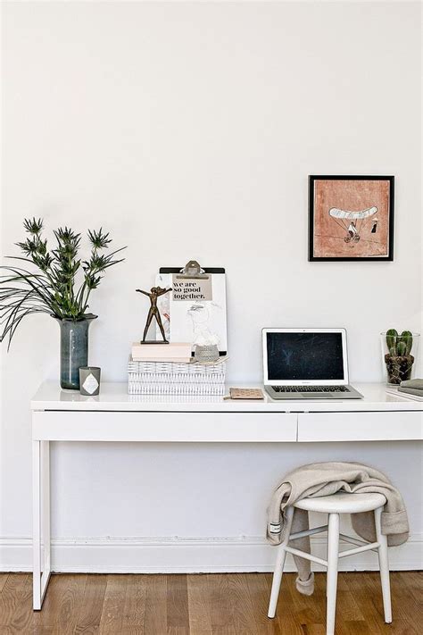 A White Desk Topped With A Laptop Computer Next To A Potted Plant