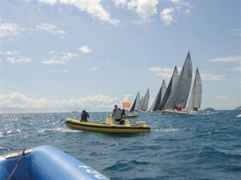 Several Small Boats In The Water With Sails On Their Backs And One Boat