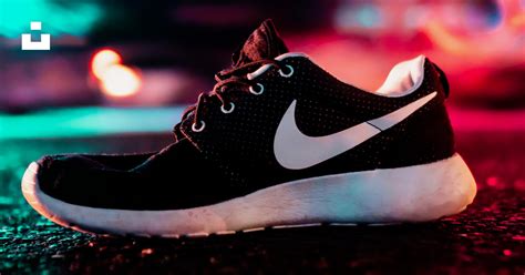 Unpaired Black And White Nike Sneaker On Road Photo Free Shoes Image