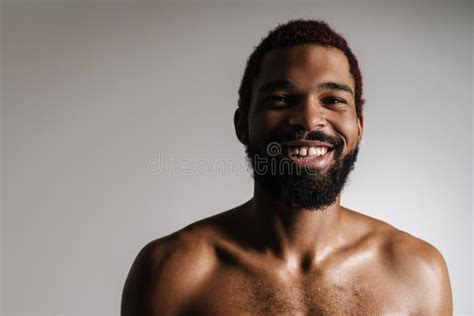 Black Shirtless Bearded Man Smiling And Looking At Camera Stock Photo