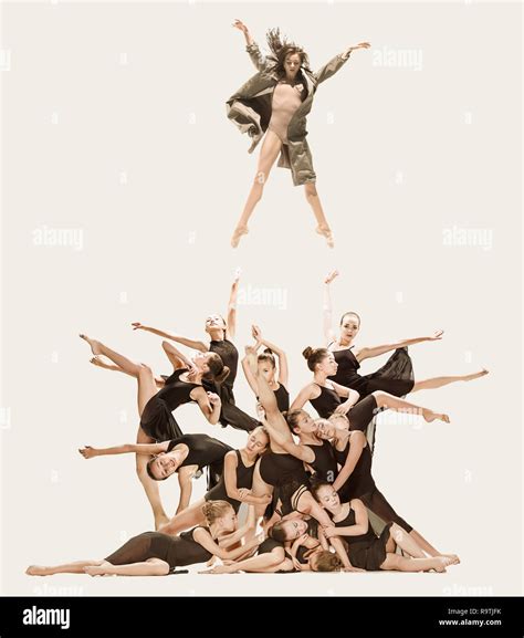 The Group Of Modern Ballet Dancers Dancing On Gray Studio Background