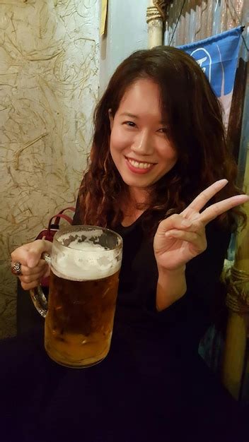 Premium Photo Portrait Of Smiling Young Woman Holding Beer While