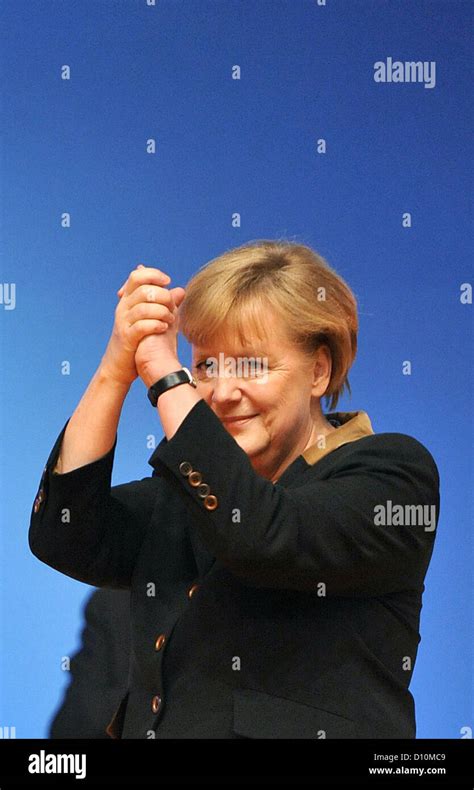 German Chancellor Angela Merkel stands after delivering her speech ...