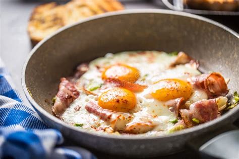 English Breakfast Fried Bacon Ham And Eggs In Ceramic Pan Stock Photo