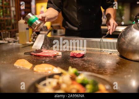 Teppanyaki Chef Cooking Japanese Wagyu Beef And Filet Mignon Steak On