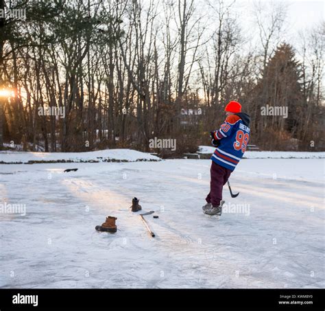 Boys Playing Ice Hockey On A Frozen Pond Stock Photo Alamy