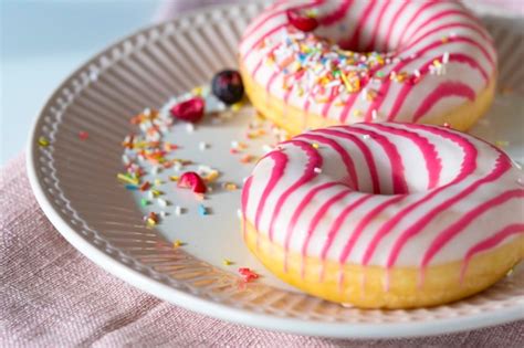 Premium Photo White Pink Frosted Donuts