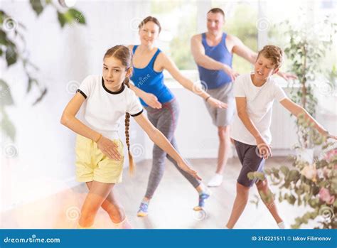 Positive Pre Teenage Dancers And Parent Doing Dance Workout During