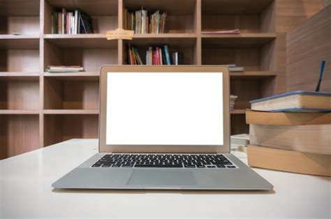 Premium Photo Laptop With Mock Up Blank Screen On Wooden Table In