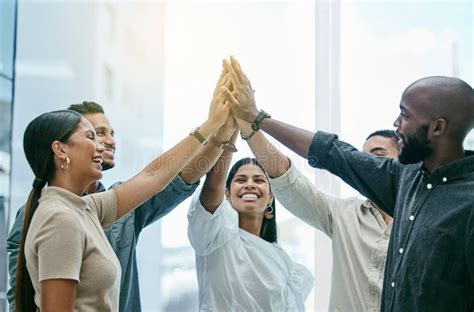 Teamwork Has Made The Dream Work A Group Of Coworkers High Fiving Each