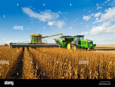 A Combine Harvester Equiped With An Air Reel On The Header Unloads