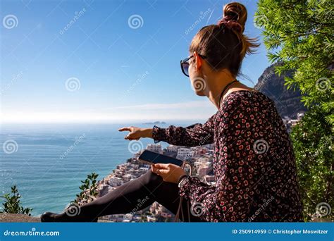 Tourist Woman With Phone Enjoying Scenic View Of The Colorful Houses Of