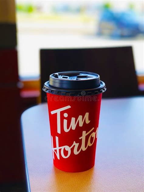 Close Up on a Cardboard Coffee Cup with Tim Hortons Logo in One of ...