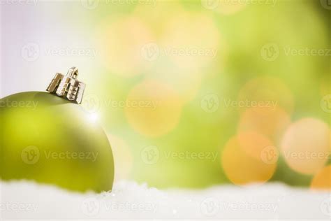 Green Christmas Ornaments On Snow Over An Abstract Background 16292226