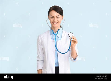 Female cardiologist on color background Stock Photo - Alamy