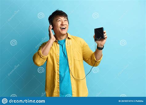 Asian Man Listening Music Positive Man Listening Radio In Earphones