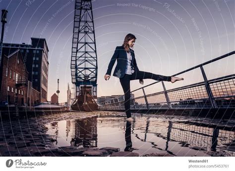 Barfoot Businesswoman Dancing At Wet Inner Harbor A Royalty Free