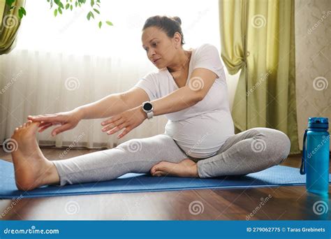 Gravid Pregnant Woman Doing Prenatal Stretching Exercises On Fitness