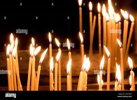 Group Of Yellow Candles In Church For Faith Resurrection Prayer