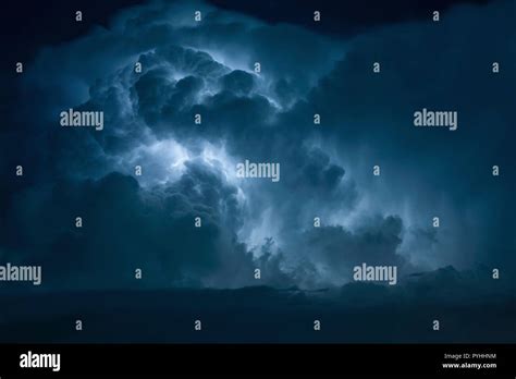 Blue Lightning strike surrounded by storm clouds Stock Photo - Alamy