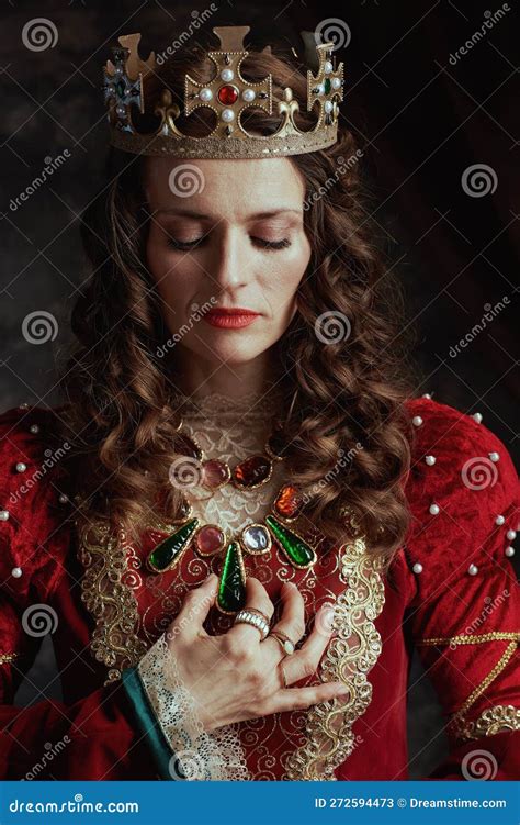 Medieval Queen In Red Dress With Crown On Dark Background Stock Image