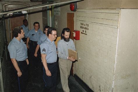 In this July 2, 1988, file photo, Gary Heidnik, right, is escorted from a holding cell in ...