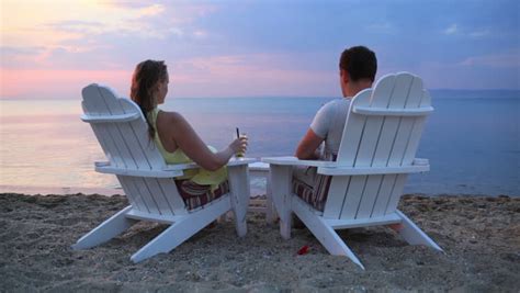 Couple Sitting In Beach Chairs With Tropical Drinks Stock Footage Video