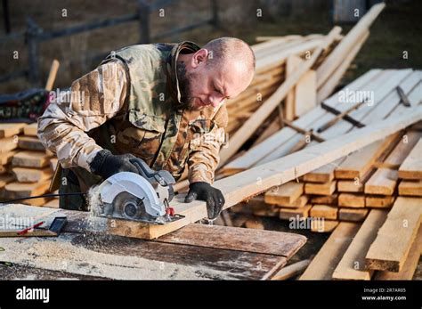 Carpenter Using Circular Saw For Cutting Wood Beam Man Worker Building