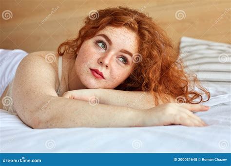 Red Haired Chubby Woman In Lingerie Lies On Bed Have Rest Stock Photo