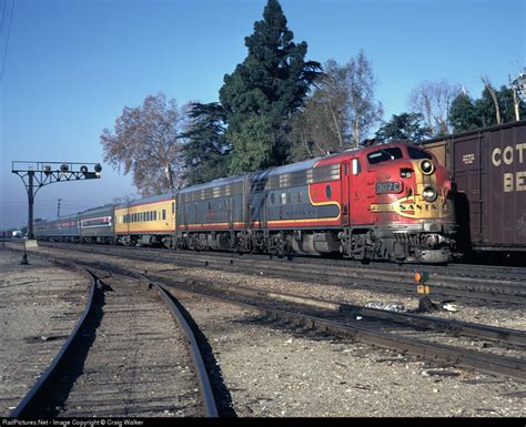 A Red And Yellow Train Traveling Down Tracks