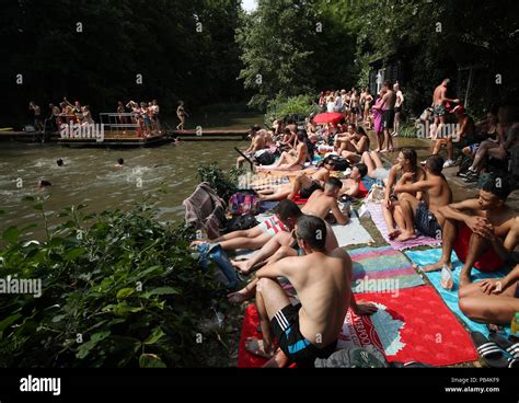 People Sunbathing At The Mixed Bathing Pond On Hampstead Heath London