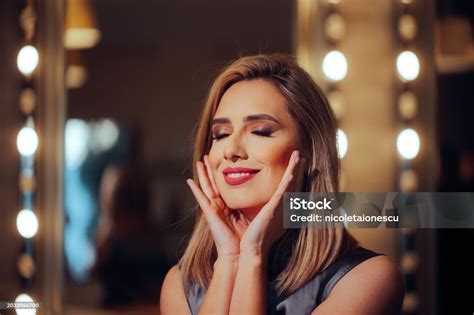 Happy Actress Wearing Stage Makeup Holding A Film Slate Stock Photo